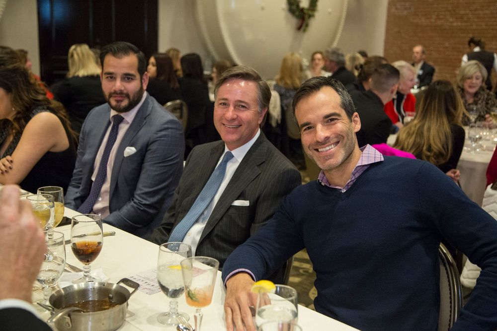Guests enjoying a formal dinner event in an elegant banquet hall setting.