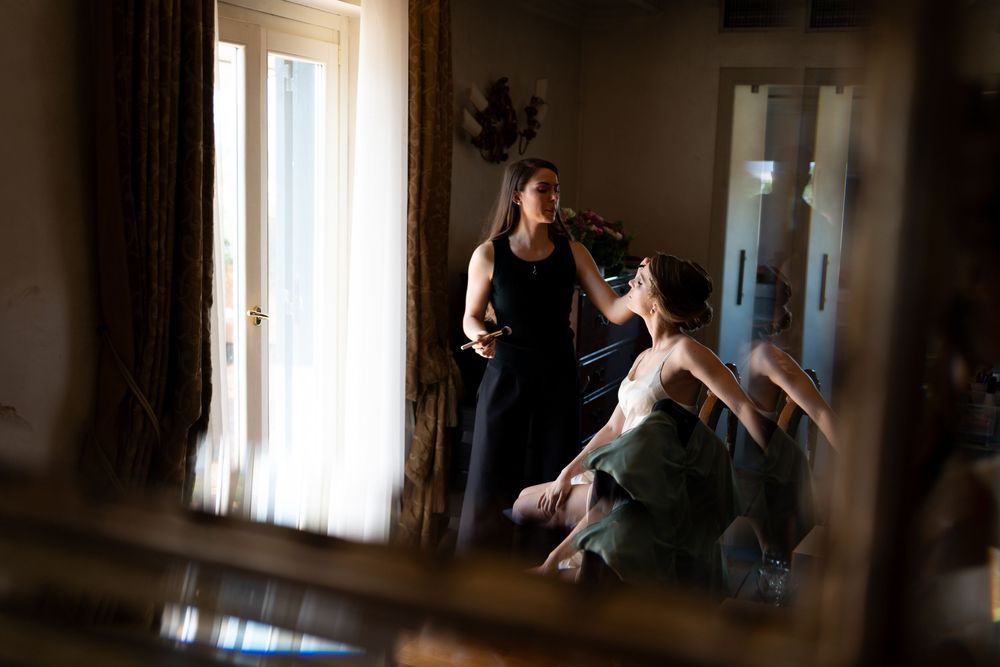 Multiple dynamic dance poses captured in silhouette against bright window light in an indoor studio space.