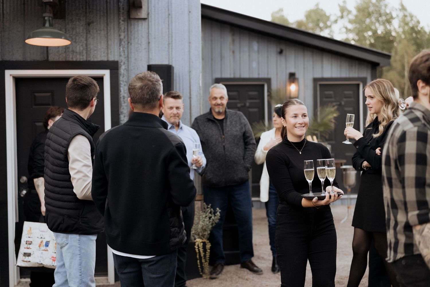 Champagne is handed out during outdoor surprise wedding at Crooked River Distillery wedding Moncton photographer New Brunswick freelance