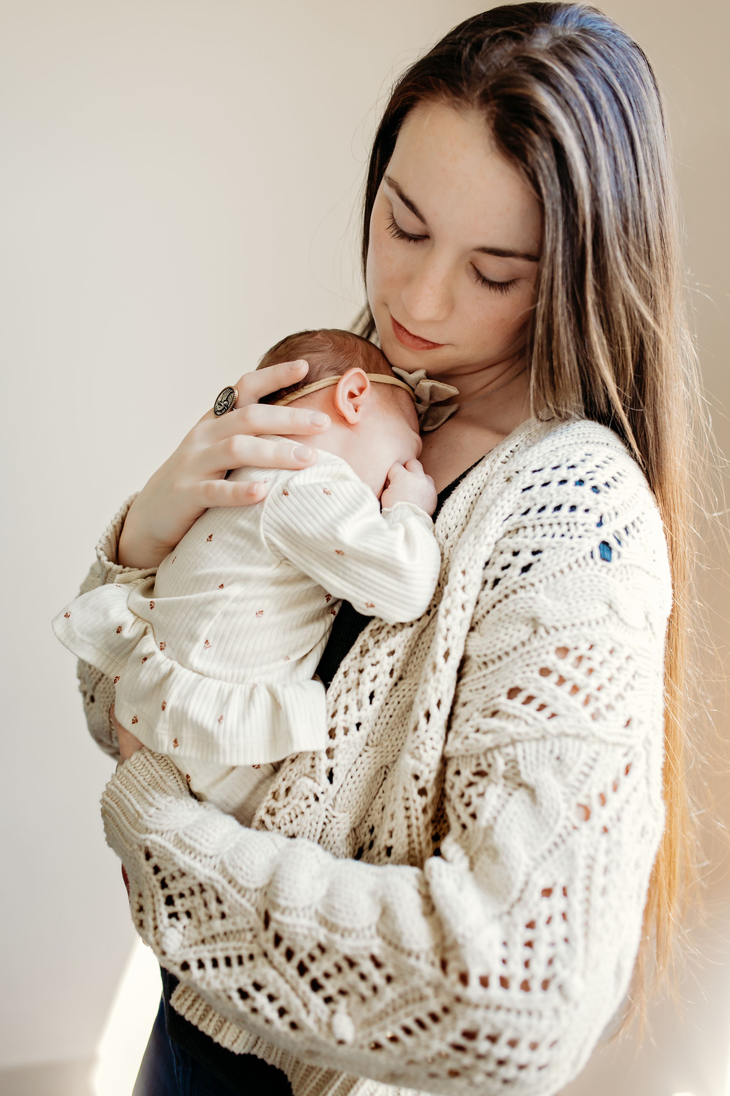 Series of intimate portraits showing tender moments with person wearing white knit sweater against neutral background.