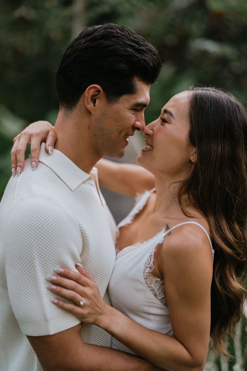 Intimate close-up of couple in white sharing romantic moment.