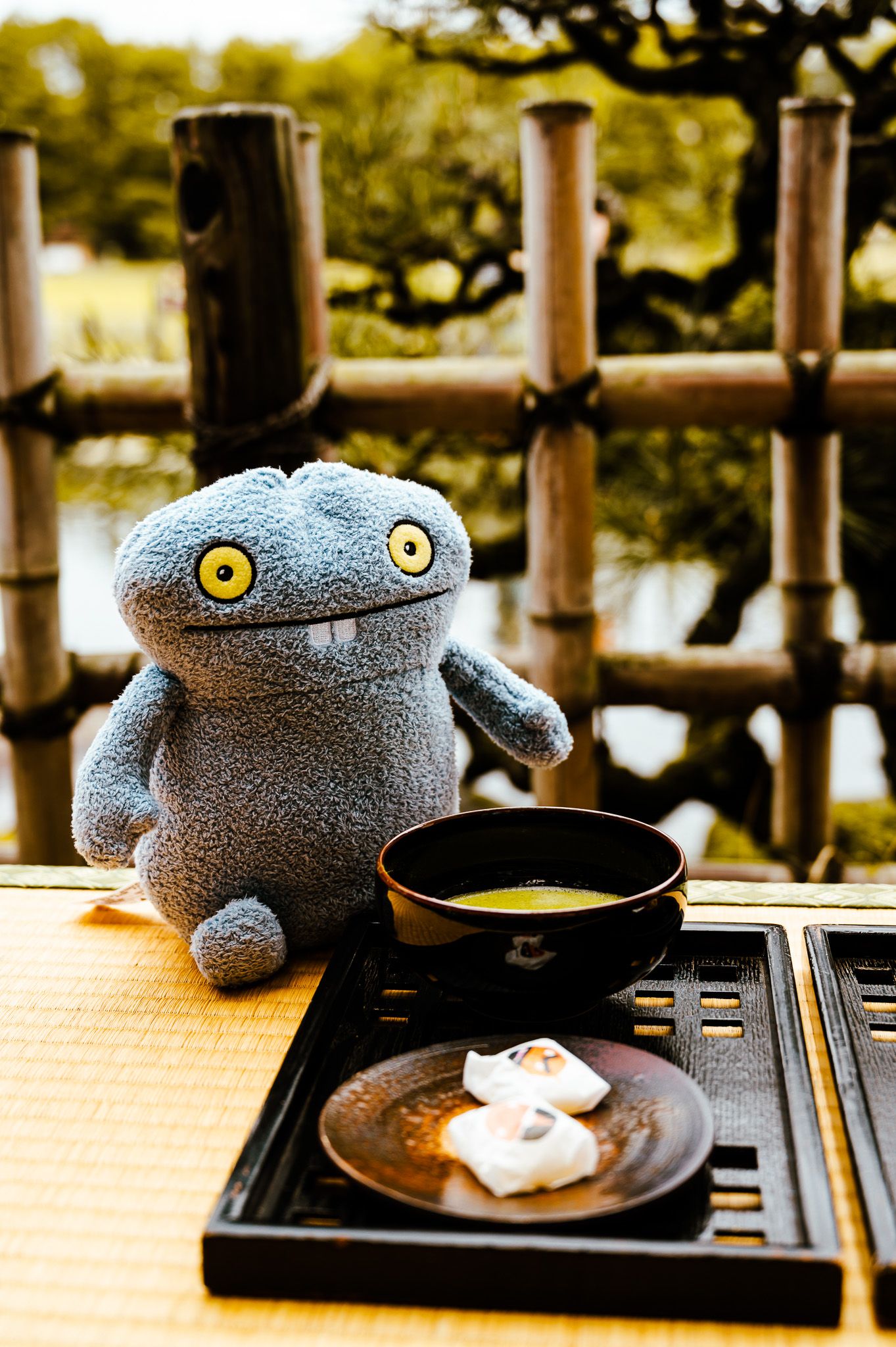 A series of photos showing a blue plush toy dinosaur sitting at a dining table with plates of food.