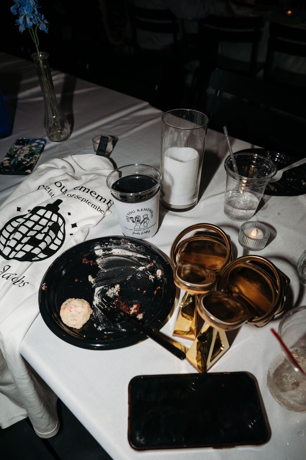 late night details image including shirt, cake plate, chunky gold heels at Denali's on the River Independence Iowa