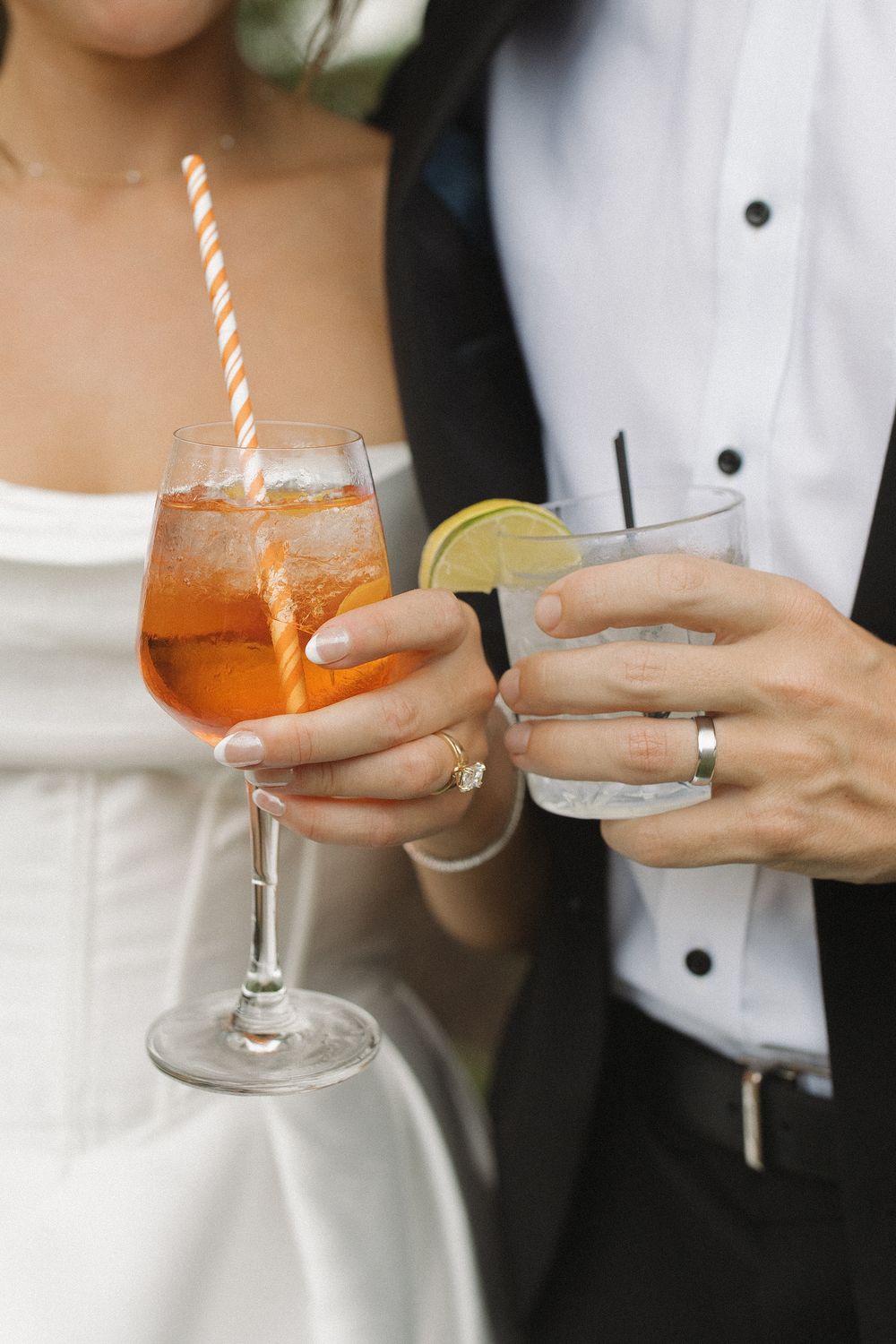 Close-up of cocktail glasses being held during a wedding reception.