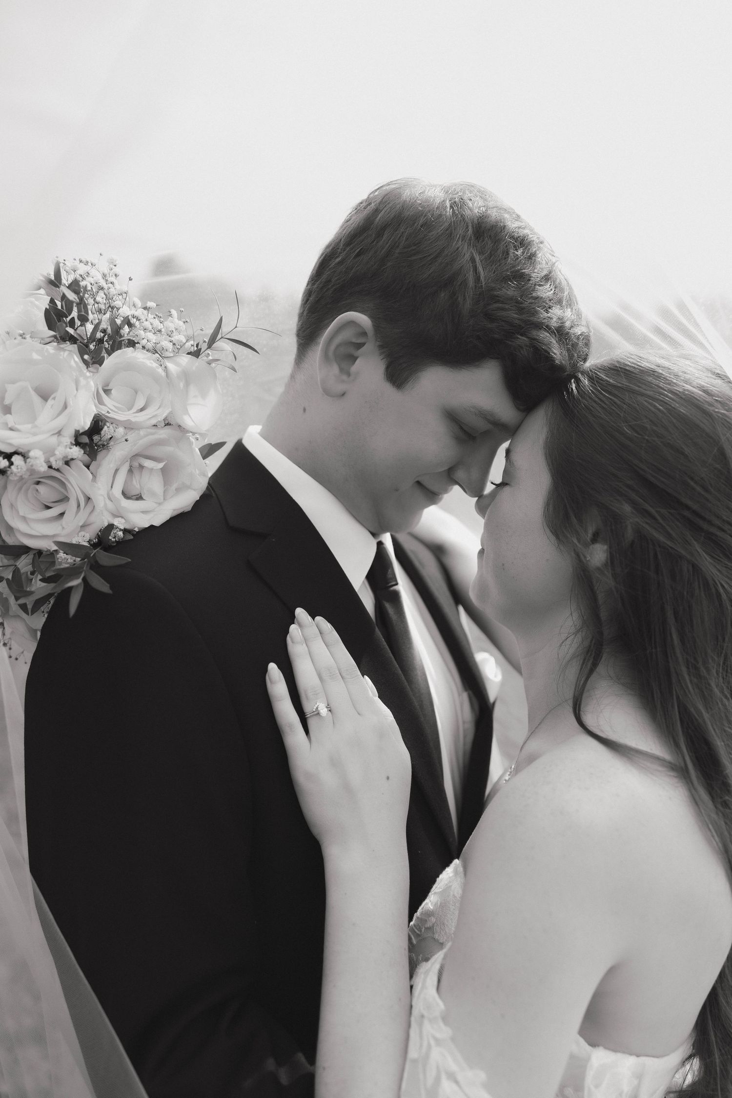 Romantic wedding portrait series showing tender embraces between a bride and groom.