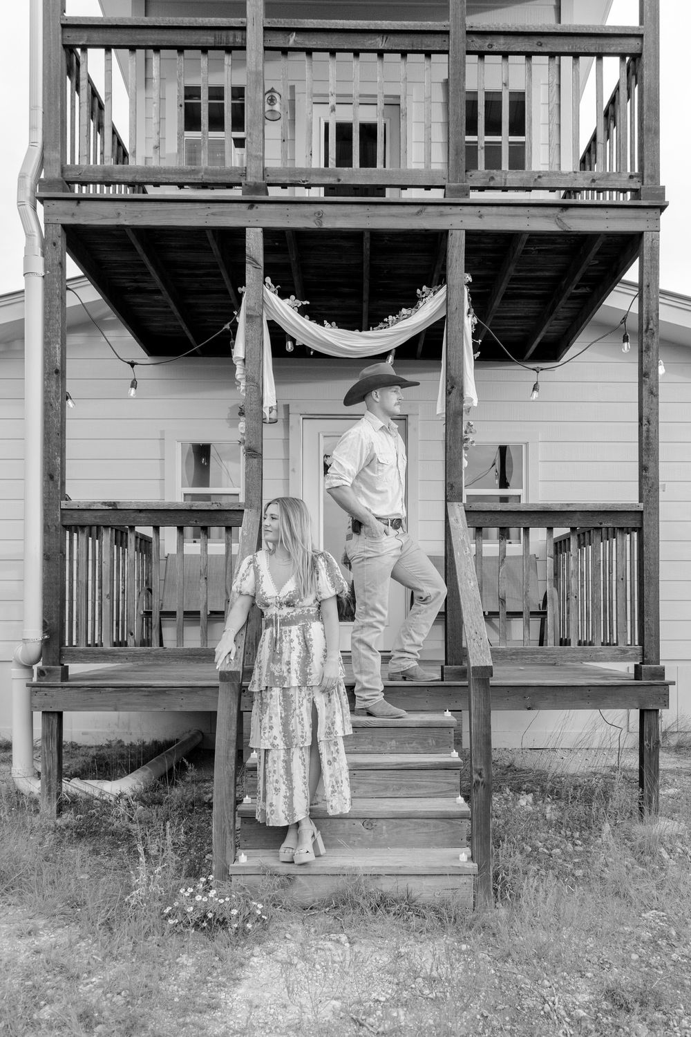 Engaged couple smiling with scenic Texas Hill Country background in Dripping Springs engagement session.