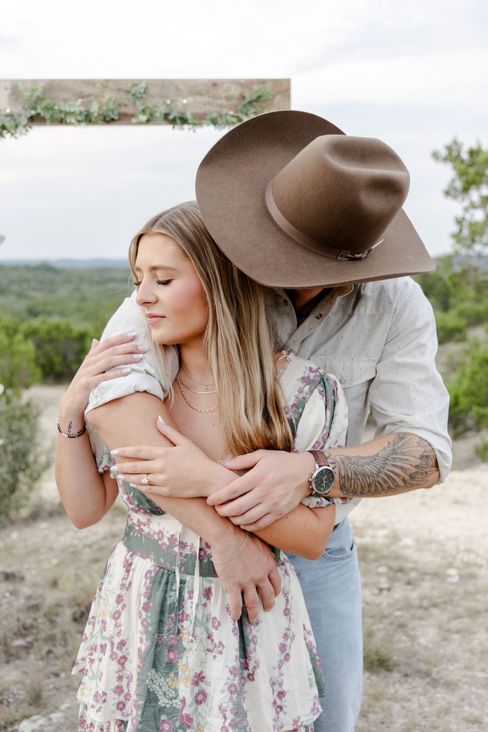 Couple celebrating immediately after engagement in romantic candlelit proposal setup in Dripping Springs Texas.