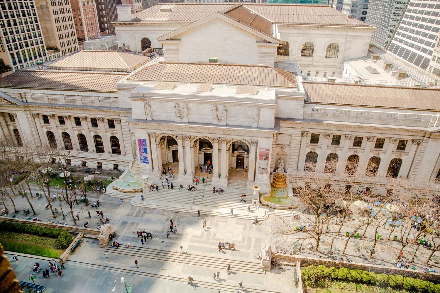 Aerial view of grand classical building with columns and public square.