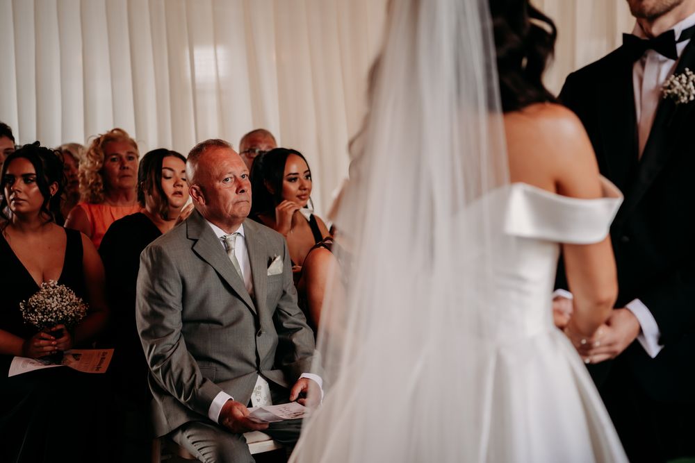 Black and white wedding reception photographs capturing emotional interactions between guests and newlyweds.