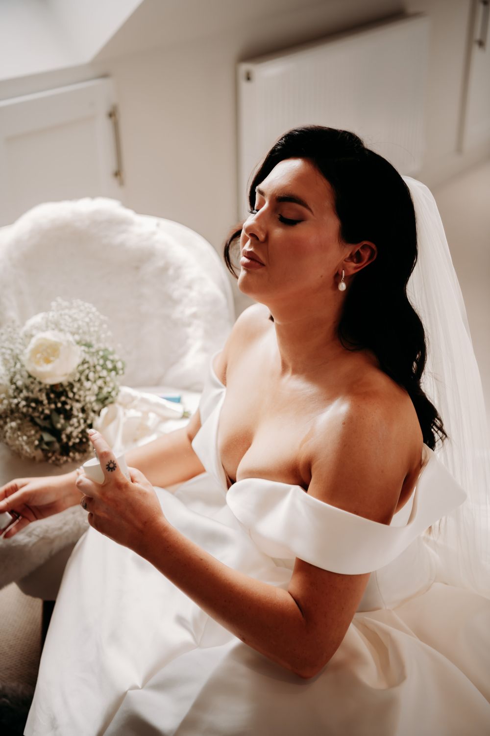 Five sequential photos showing a bride in white dress and veil tossing her head back in soft natural light.