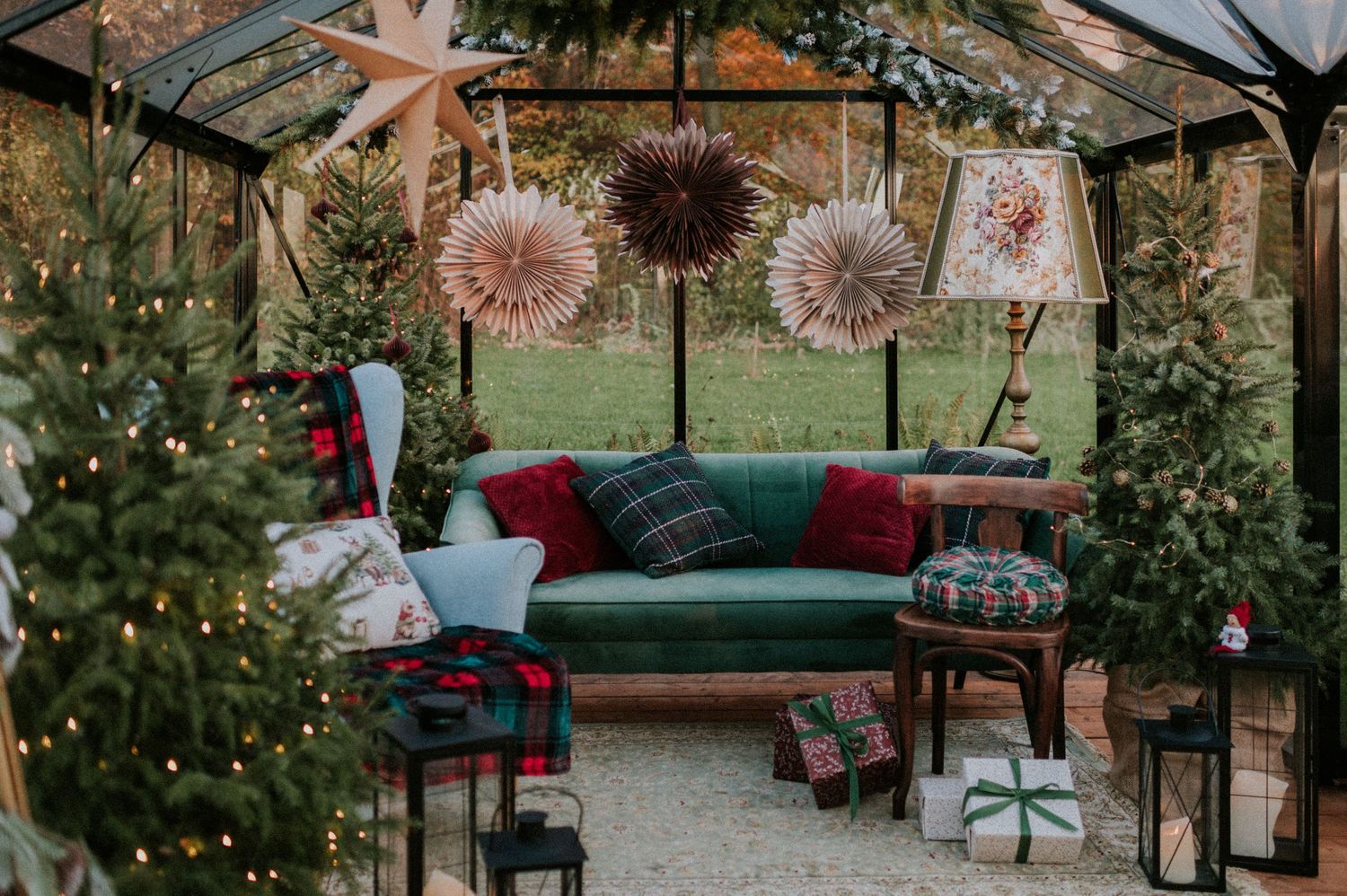 A cozy outdoor patio decorated with string lights, lush greenery, and comfortable seating for entertaining guests.