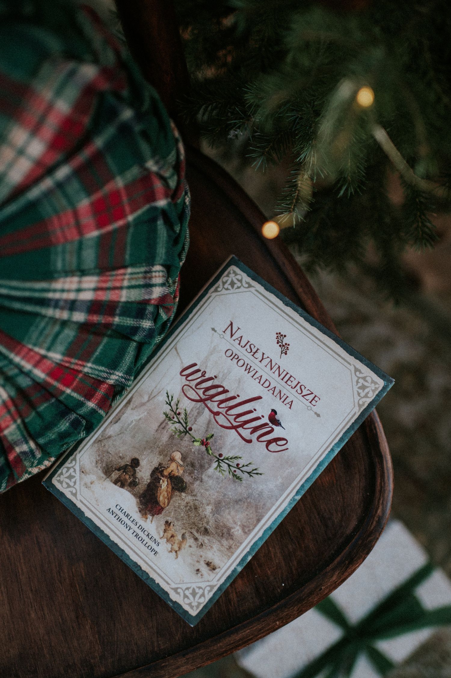 Christmas-themed decorative cards and tags with plaid patterns and text in a moody holiday setting.