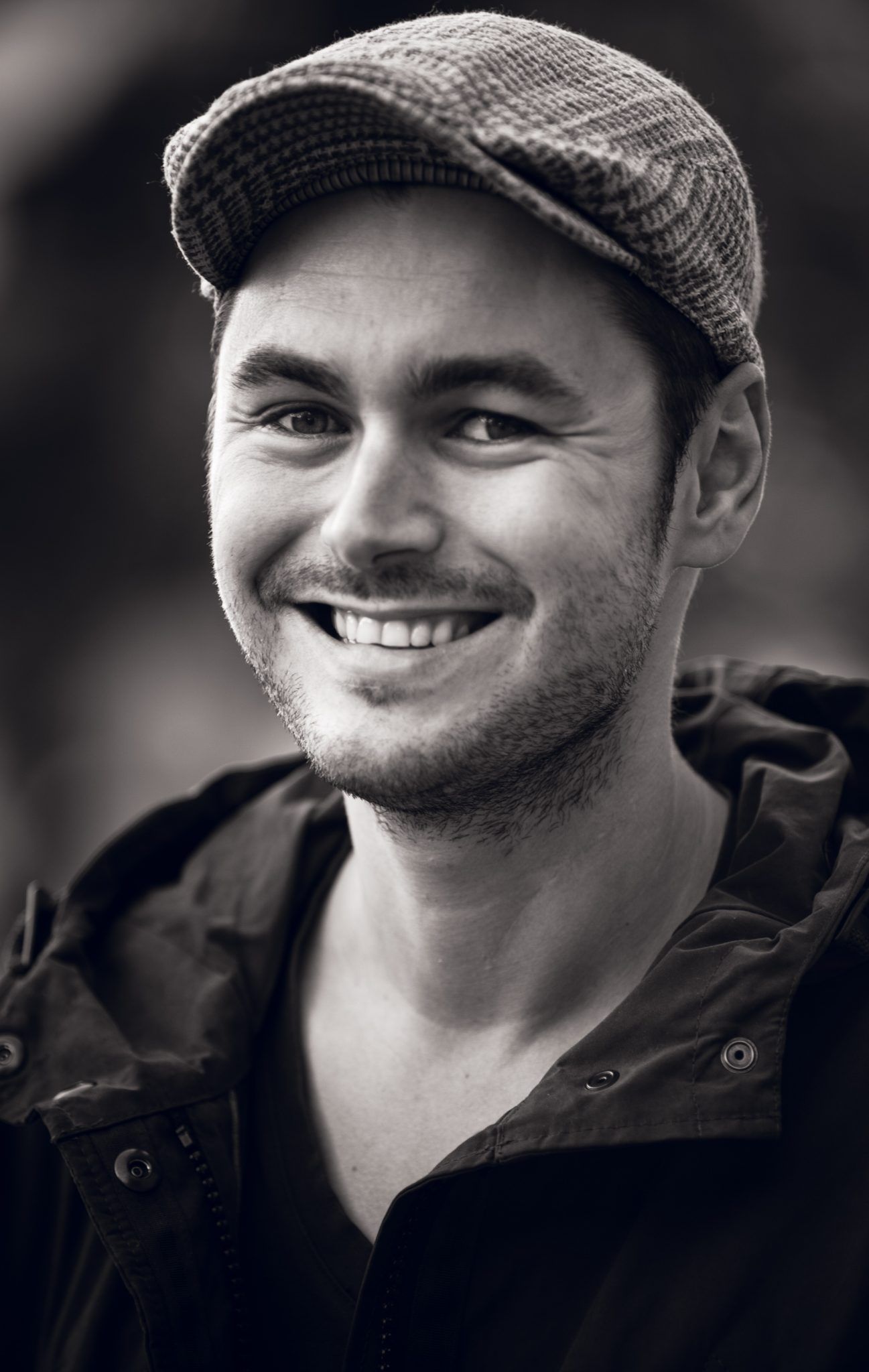 Candid black and white portrait series showing happy expressions with the wedding photographer Christoph Haslinger-Galipeau from Salzburg