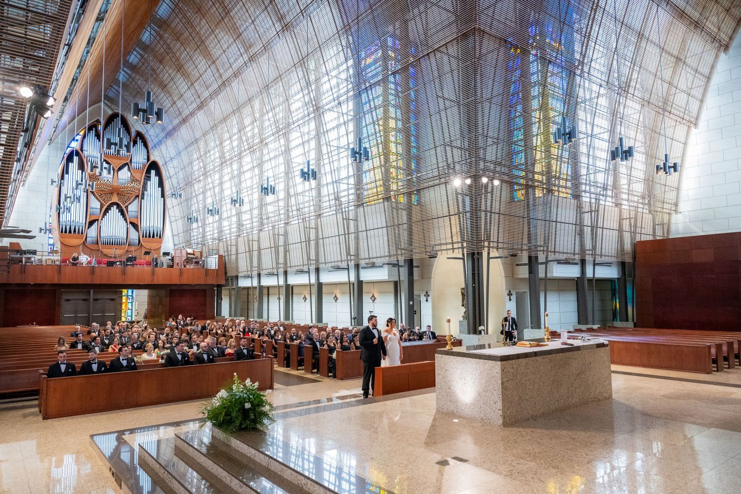 Modern glass-enclosed church interior with high ceilings and architectural details.