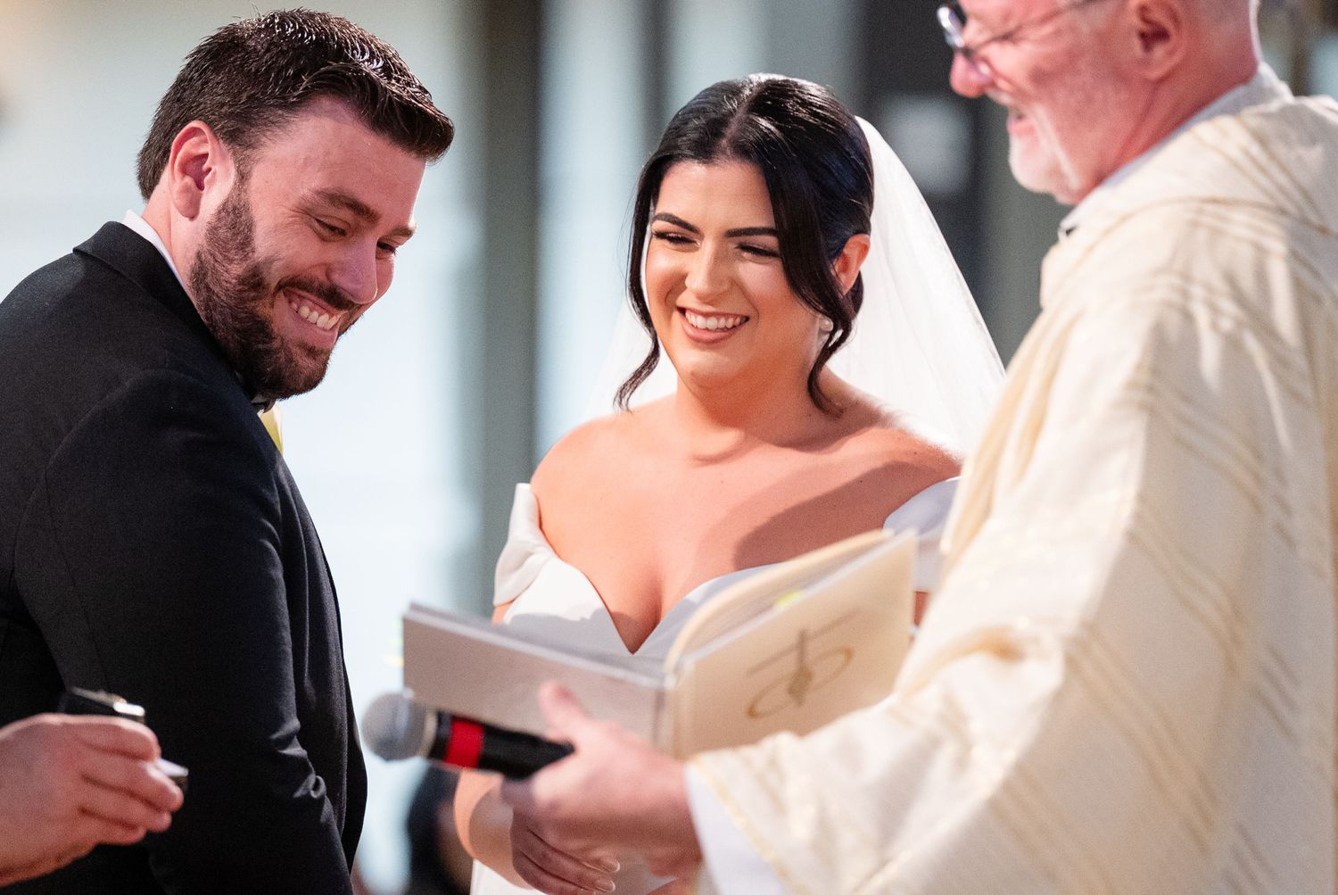 Wedding ceremony proceedings at the altar with officiant and couple.