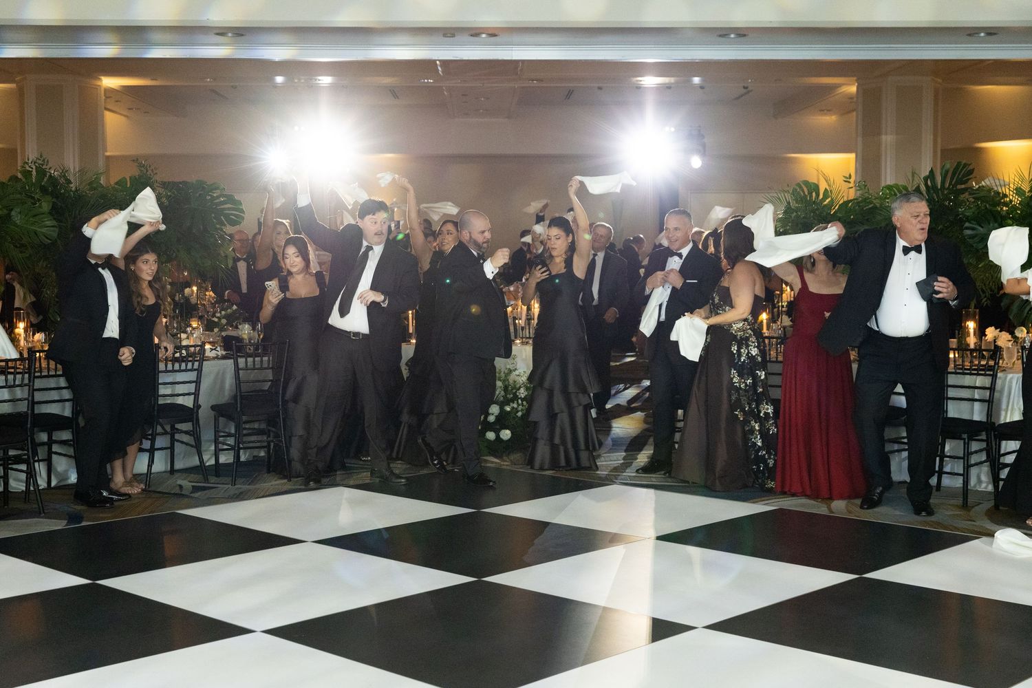 Formal wedding reception venue with black and white checkered dance floor.