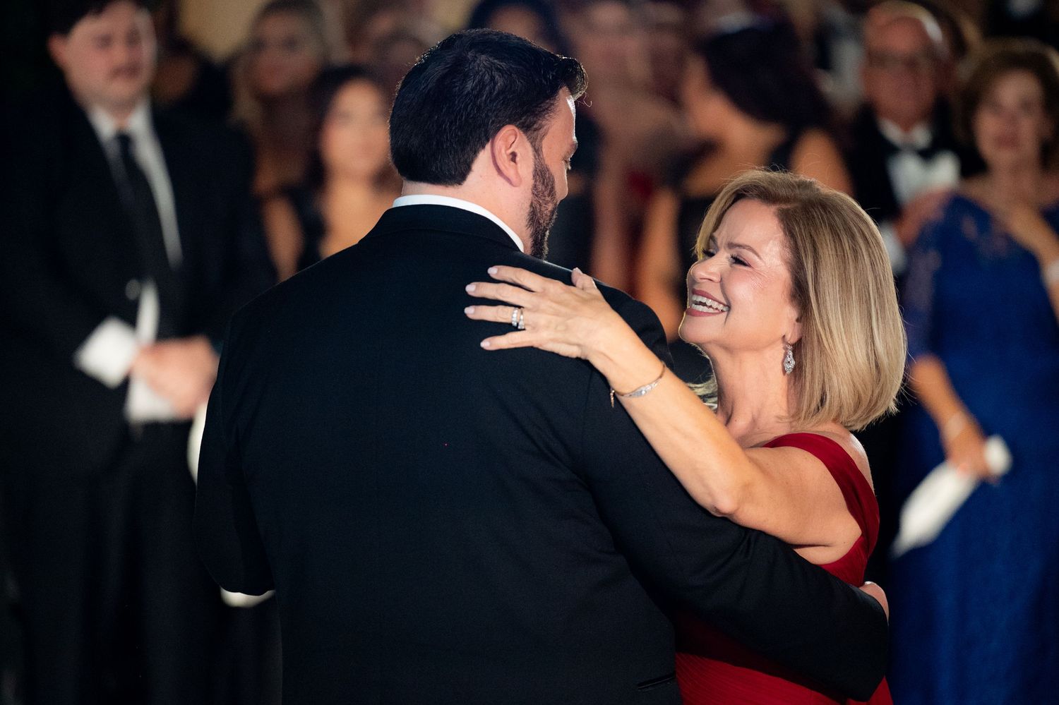 Guests in formal attire dancing and celebrating at an elegant evening event.