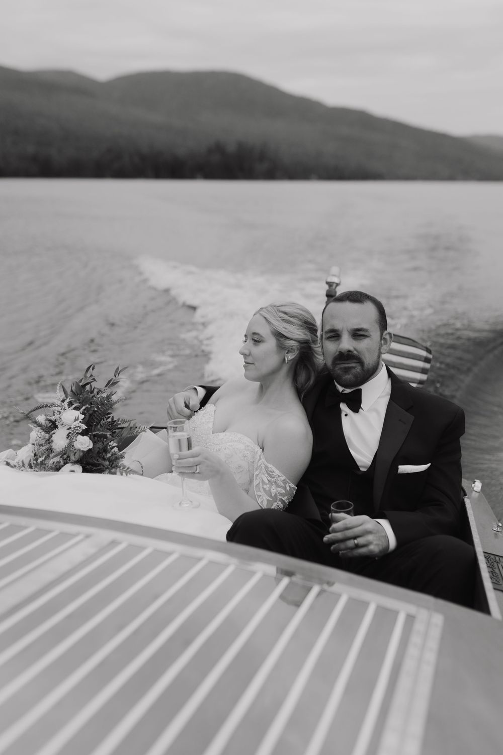 A romantic black and white photo sequence of a couple on a boat deck with mountains in the background.