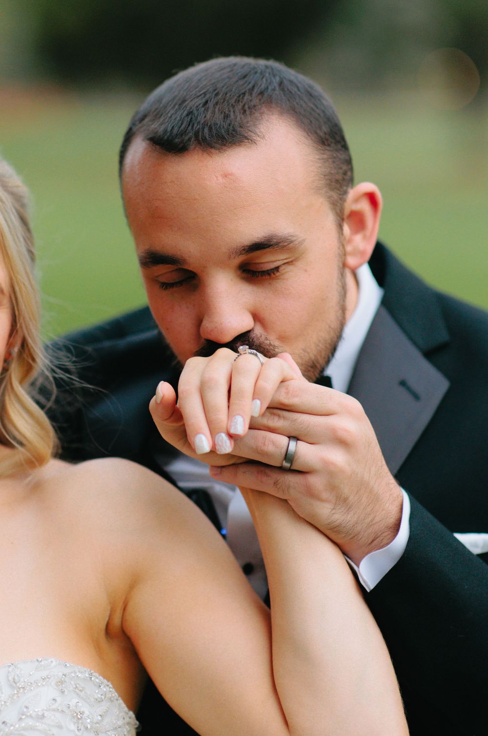 Romantic wedding couple shares an intimate moment during their first look photoshoot outdoors.