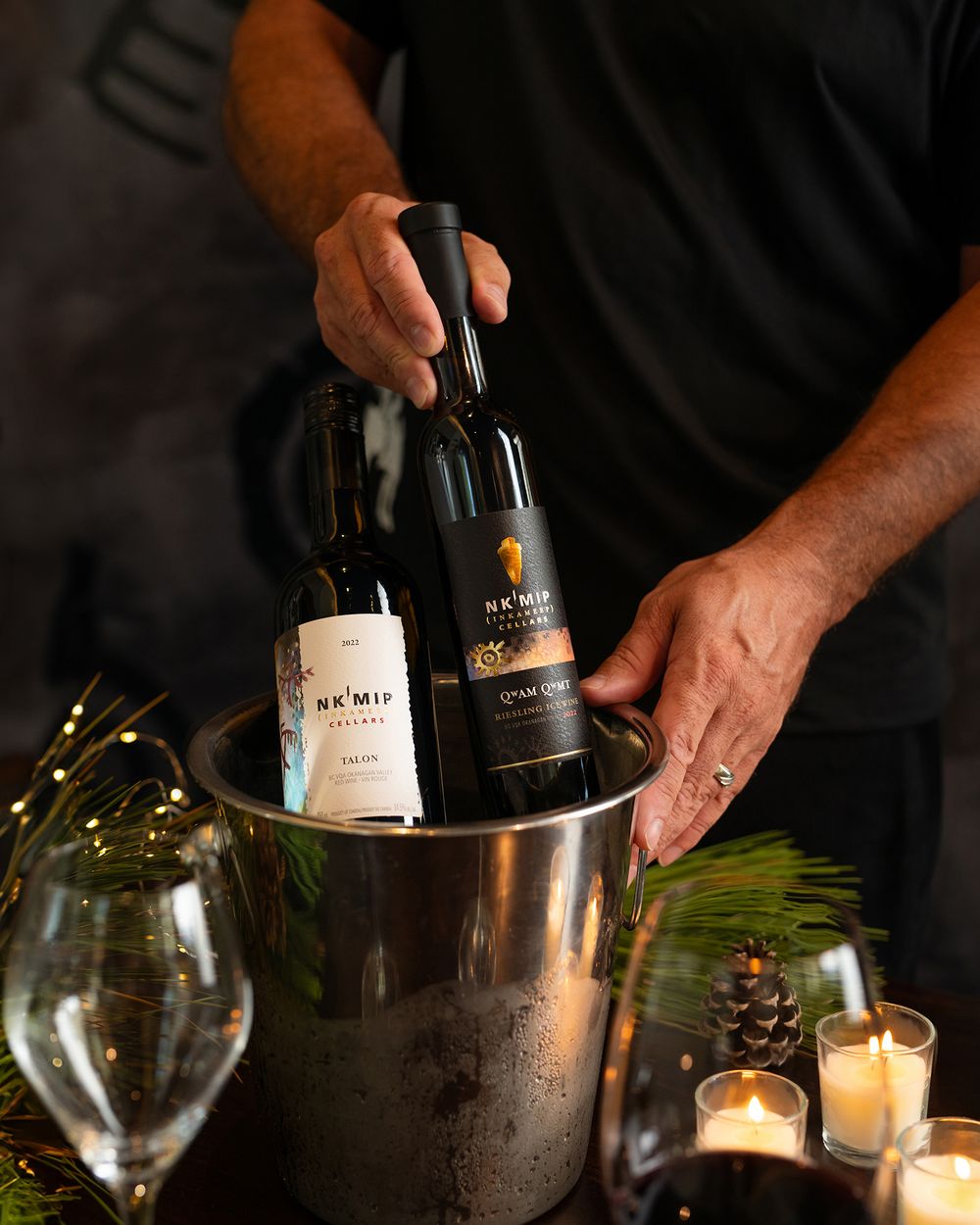 Nk’Mip Cellars wine bottles chilling in an ice bucket on a holiday table.