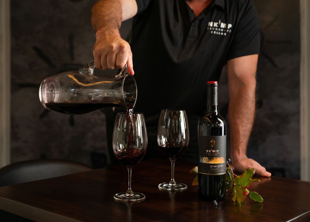 Wine being decanted into glasses at Nk’Mip Cellars during a winery photography session.