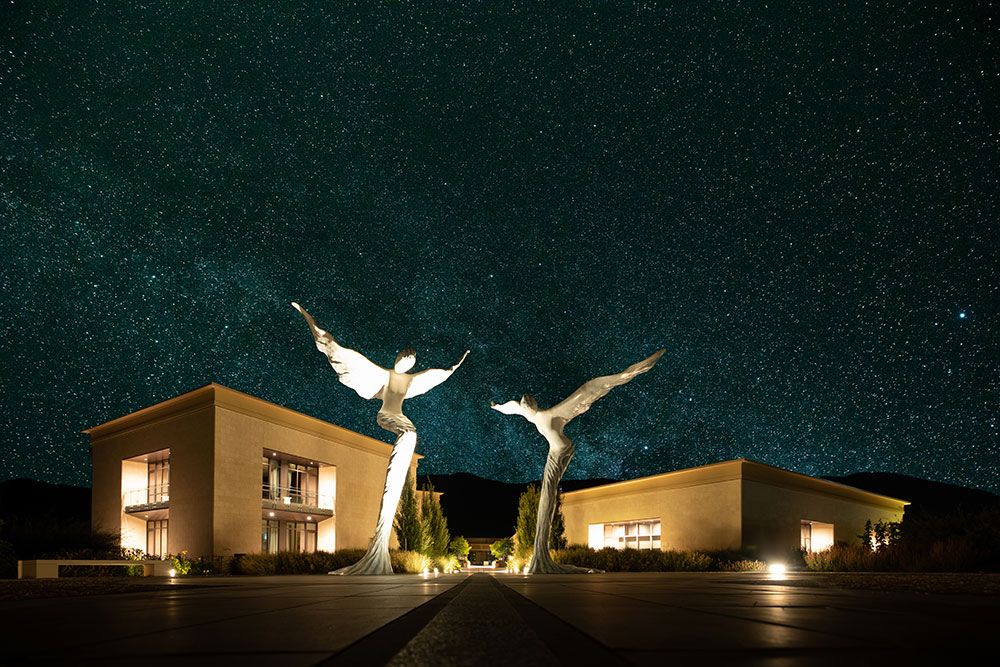 Composite night photo of Phantom Creek Estates Winery with angel statues and starry sky - Okanagan brand photography by Tania Veitch.
