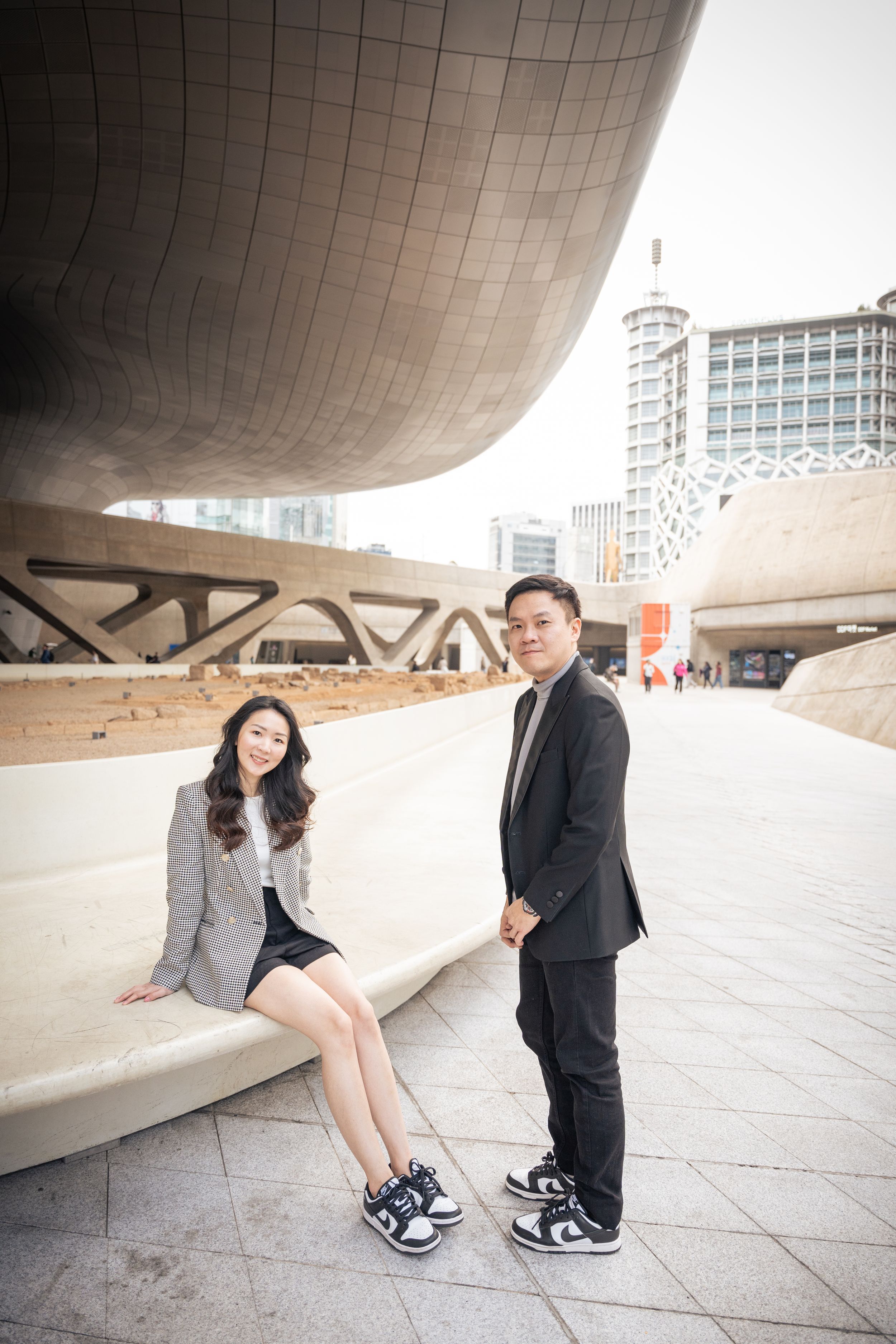 Series of photos under a curved concrete structure with modern architectural details.