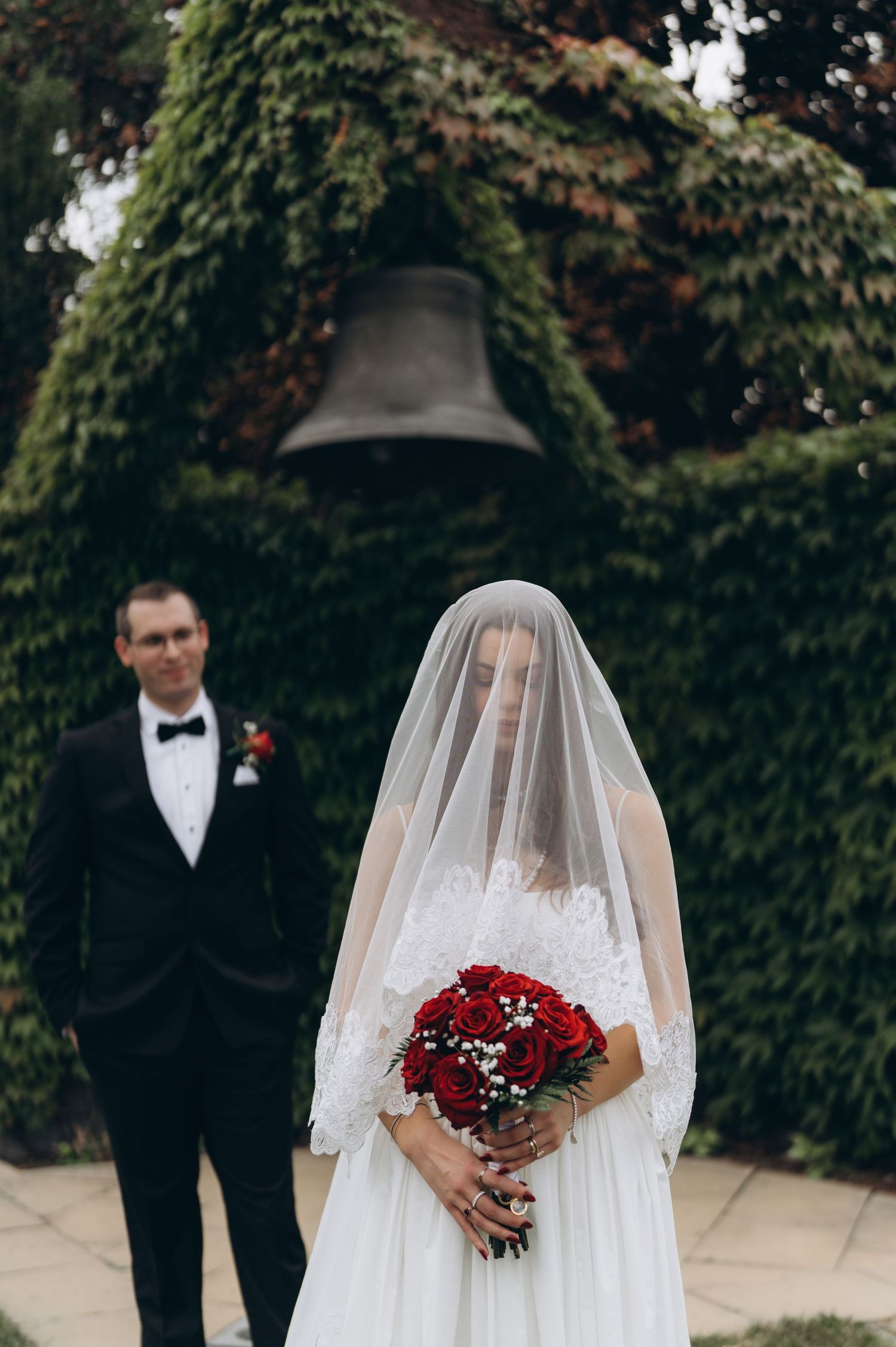 A romantic wedding photo series shows tender moments between a bride in white veil and groom in black suit.