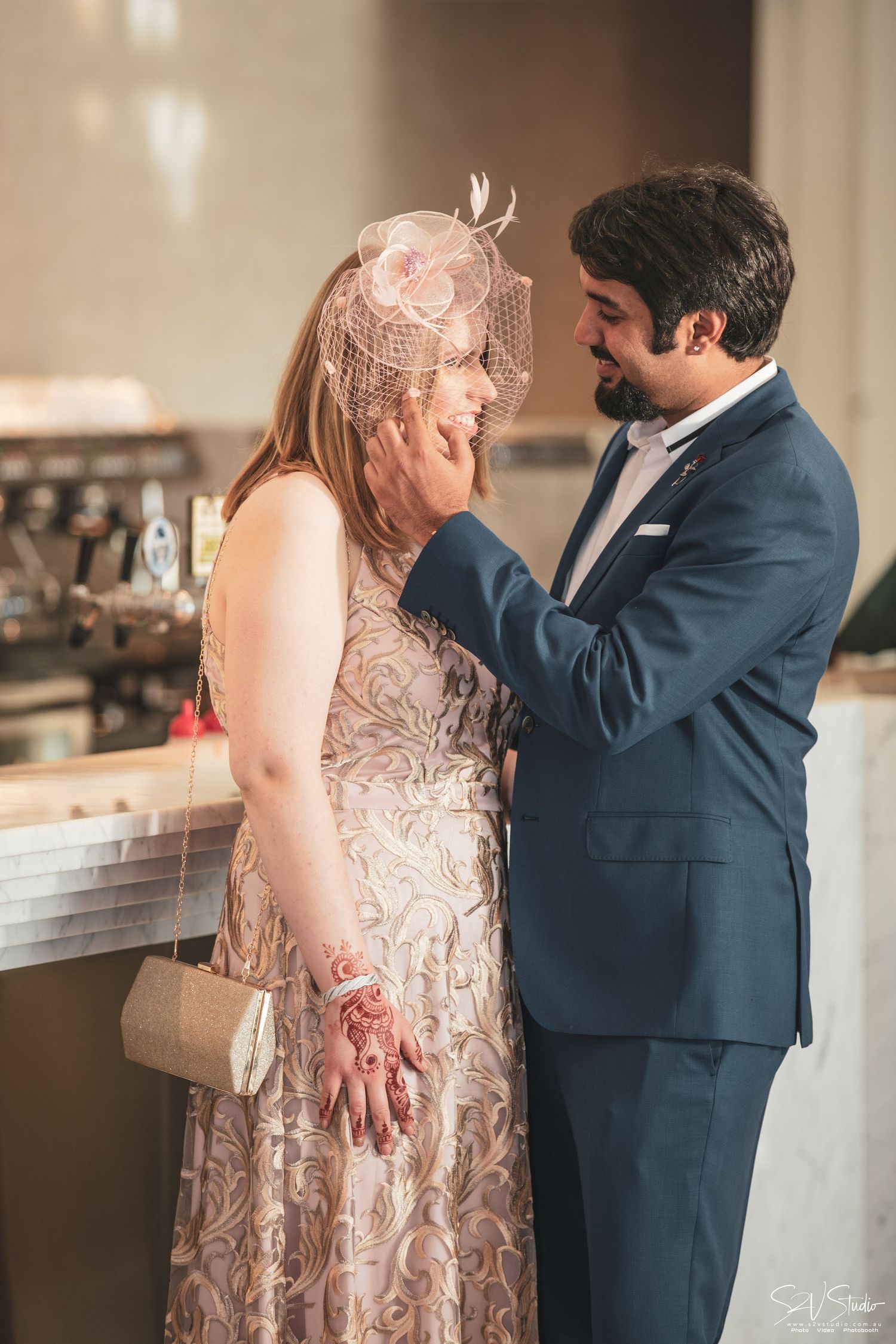 A series of wedding moments showing a couple during what appears to be their first look in a beautifully lit indoor setting.
