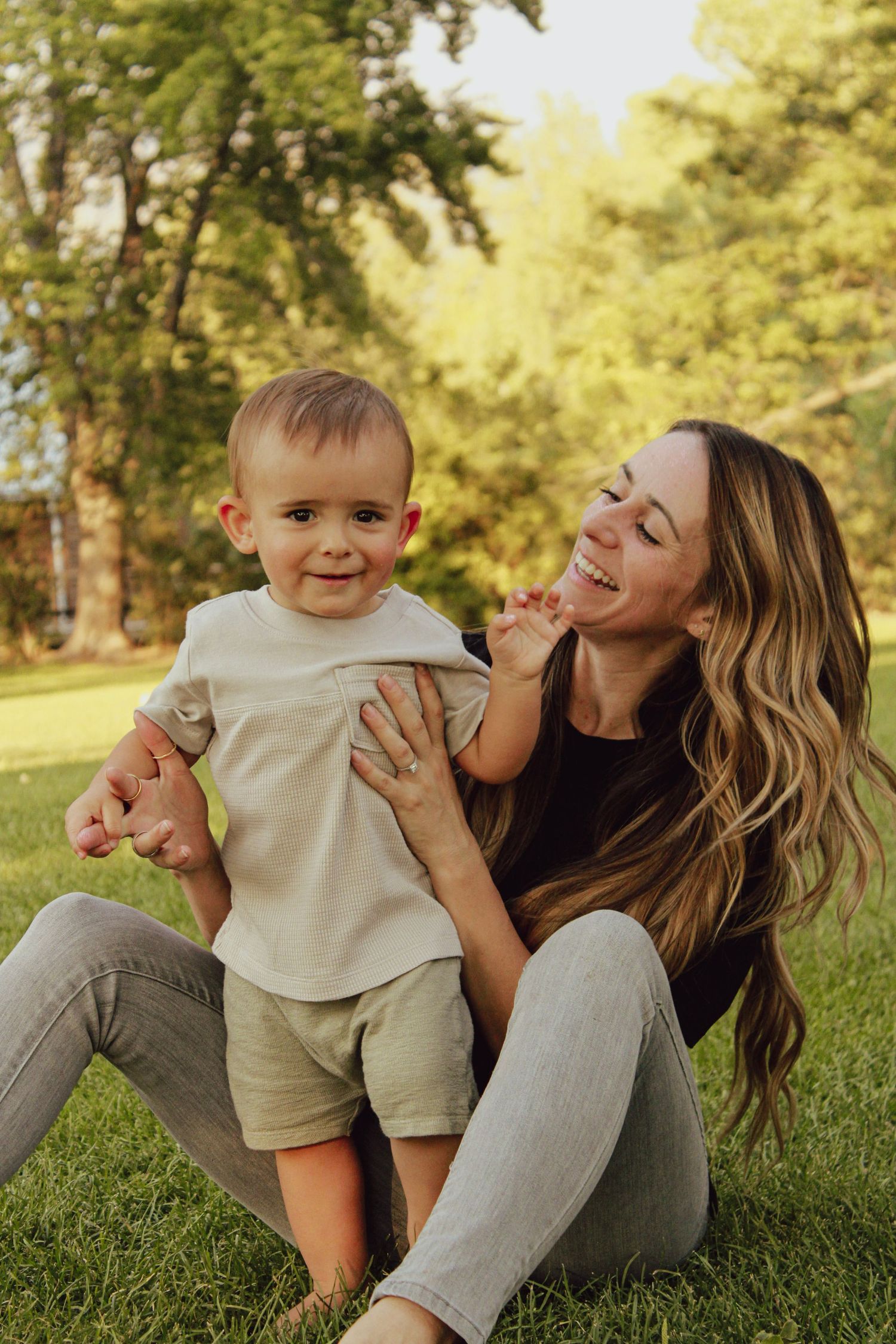 Playful outdoor photo sequence on grass showing affectionate moments in golden evening light.