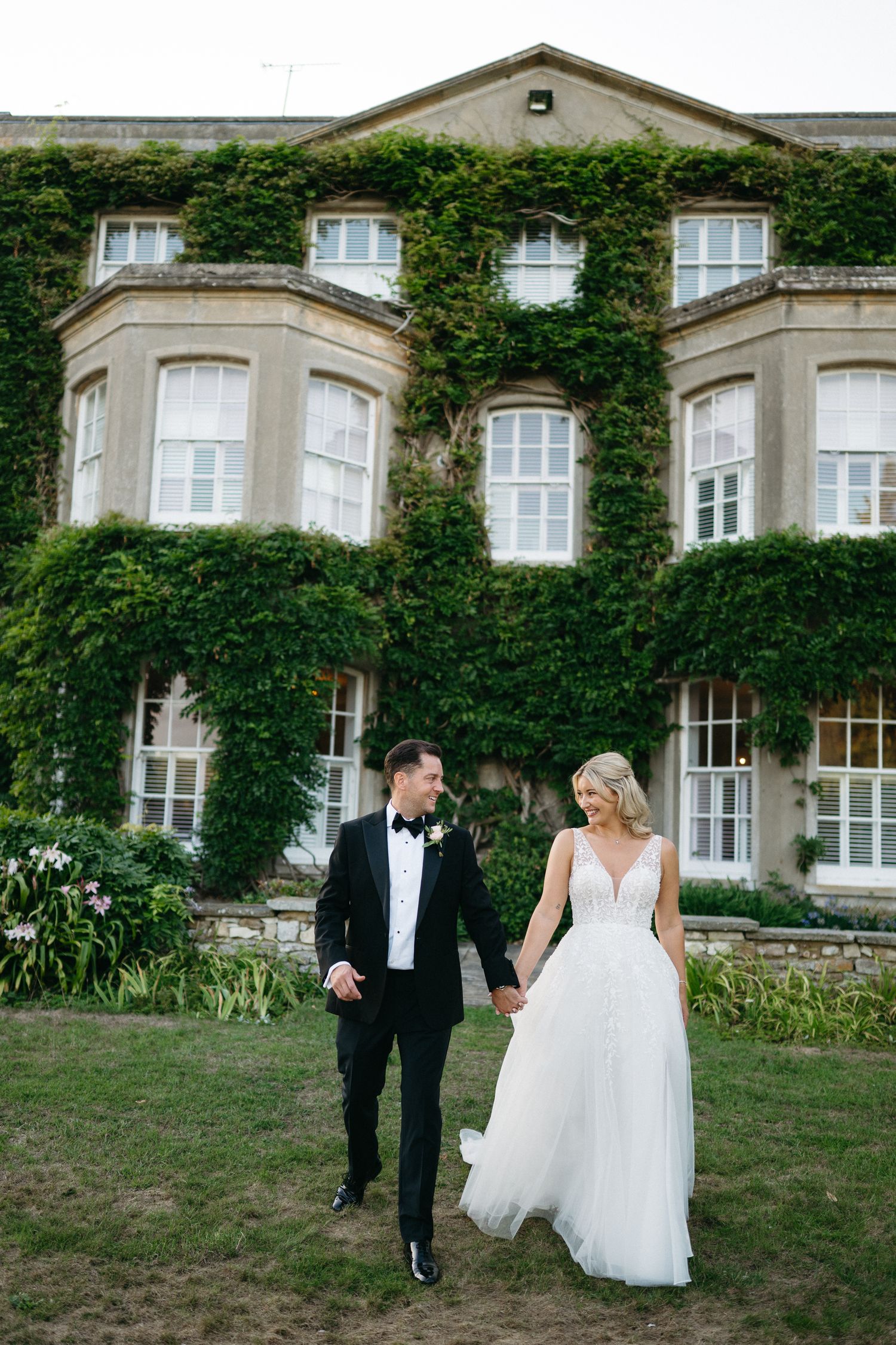 A romantic wedding portrait series at a historic ivy-covered mansion with classic elegant landscaping and architecture.