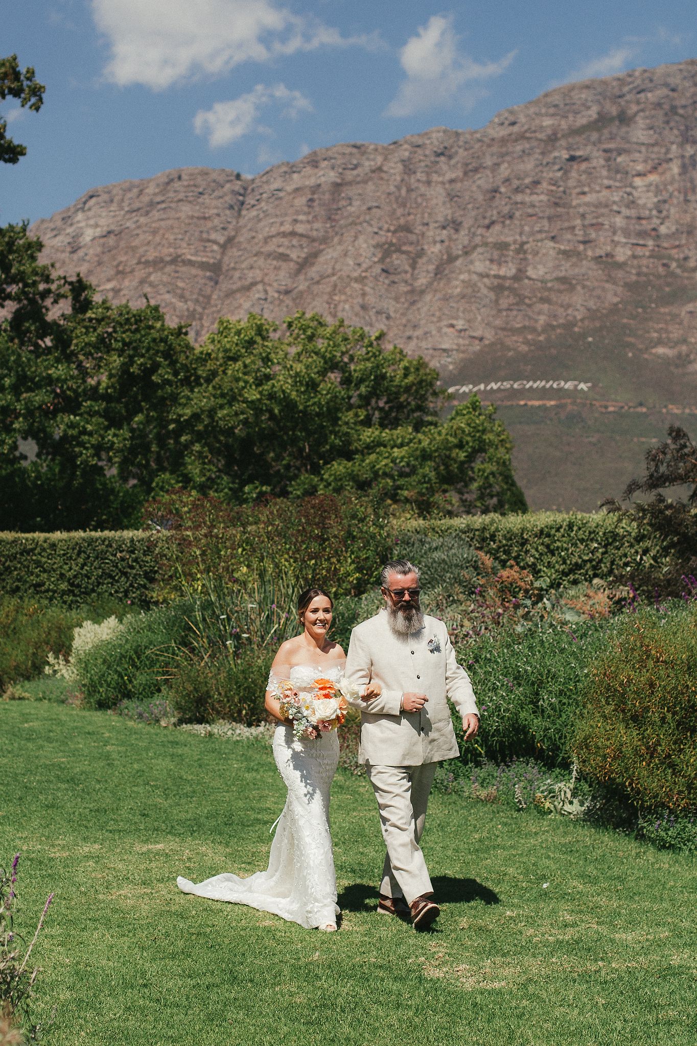 Bride walking down the aisle with her father at La Cotte, Franschhoek
