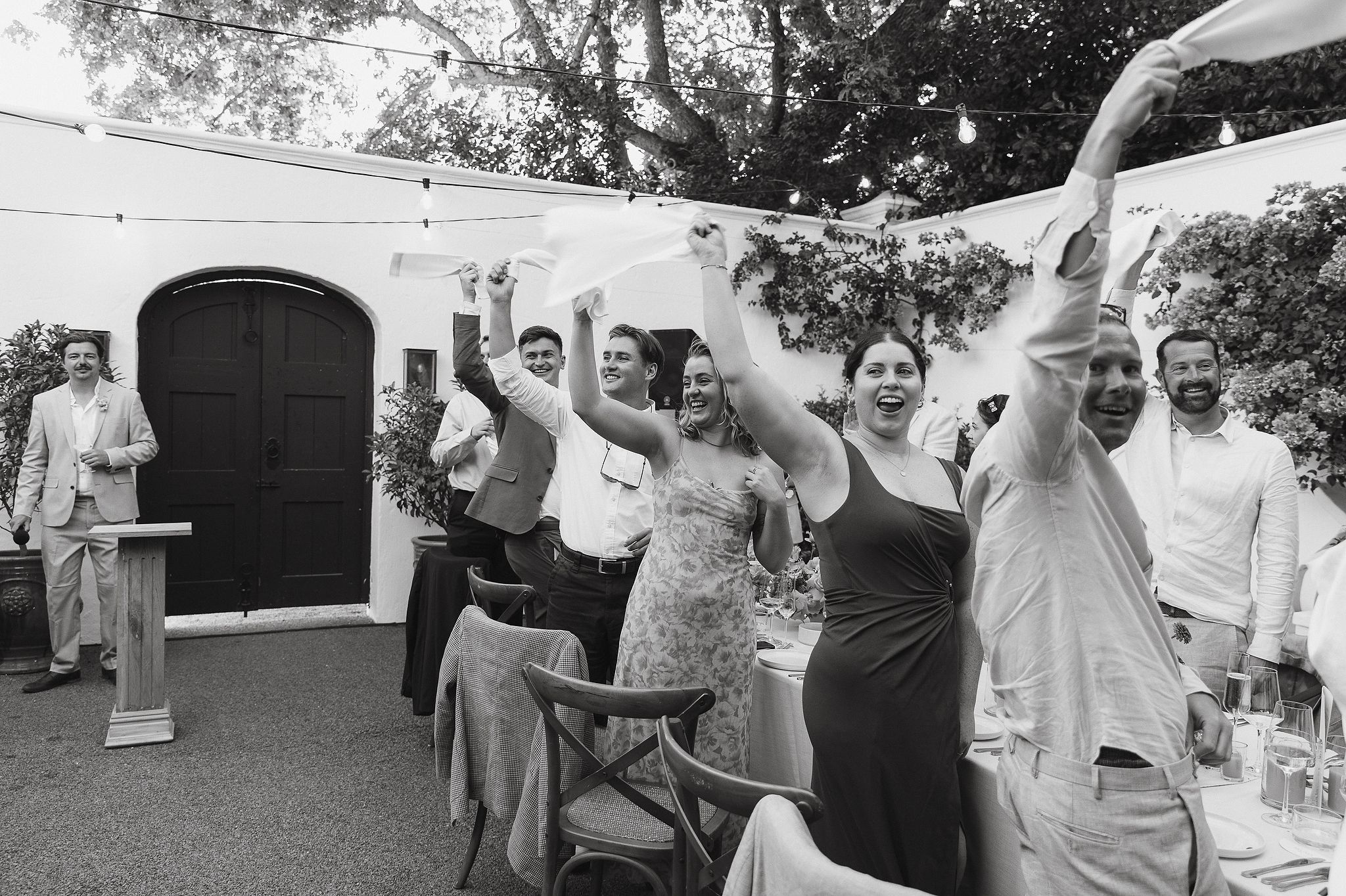 Bride and groom entering their outdoor wedding reception at La Cotte