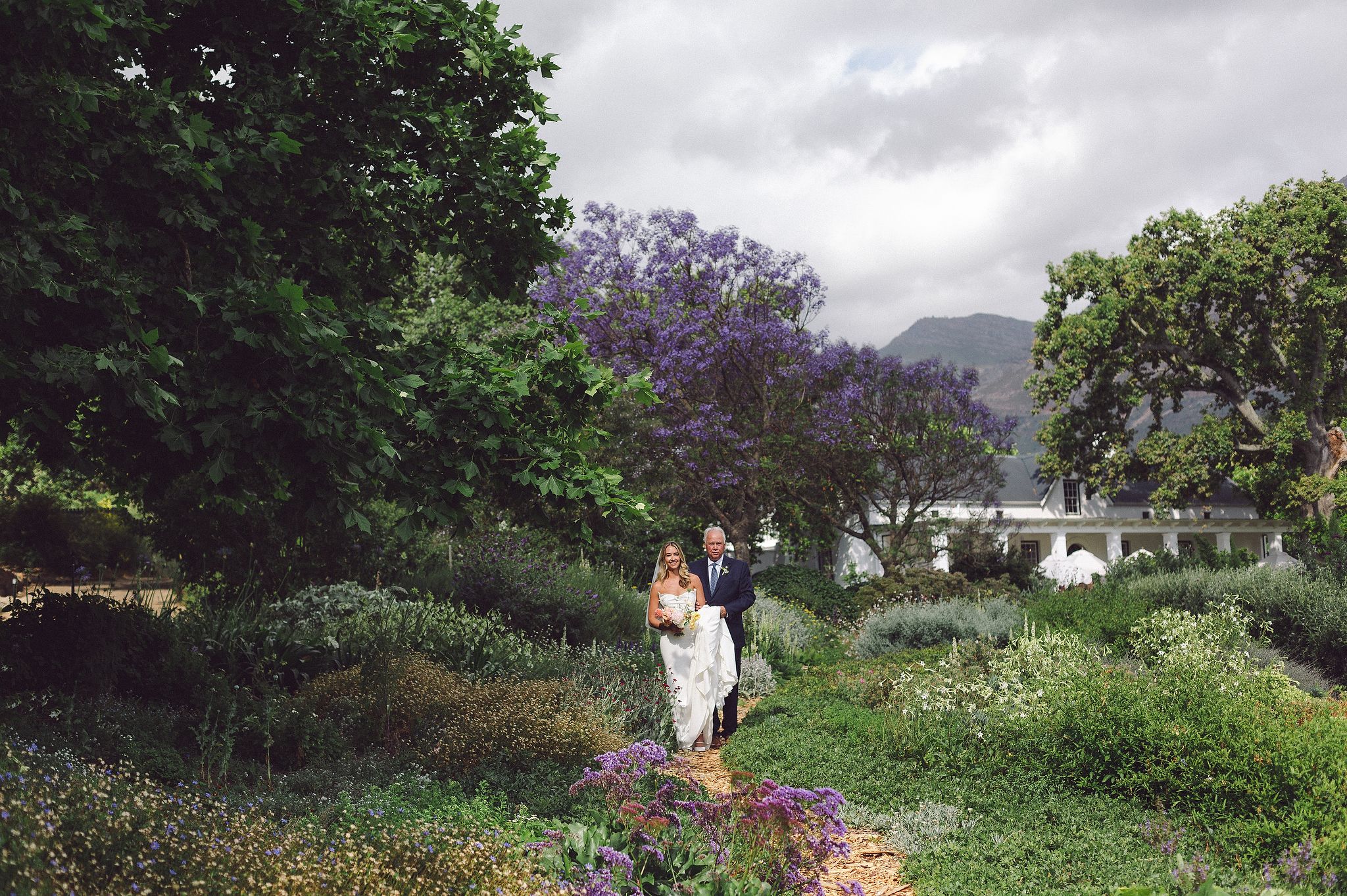 Bride and groom portraits at La Cotte in Franschhoek with mountain views