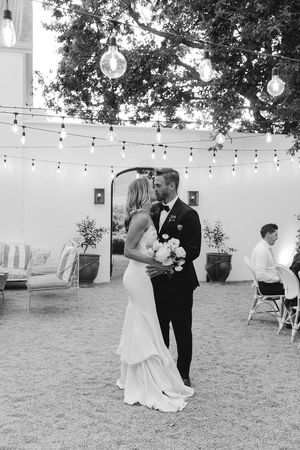 Bride and groom entering their outdoor wedding reception at La Cotte