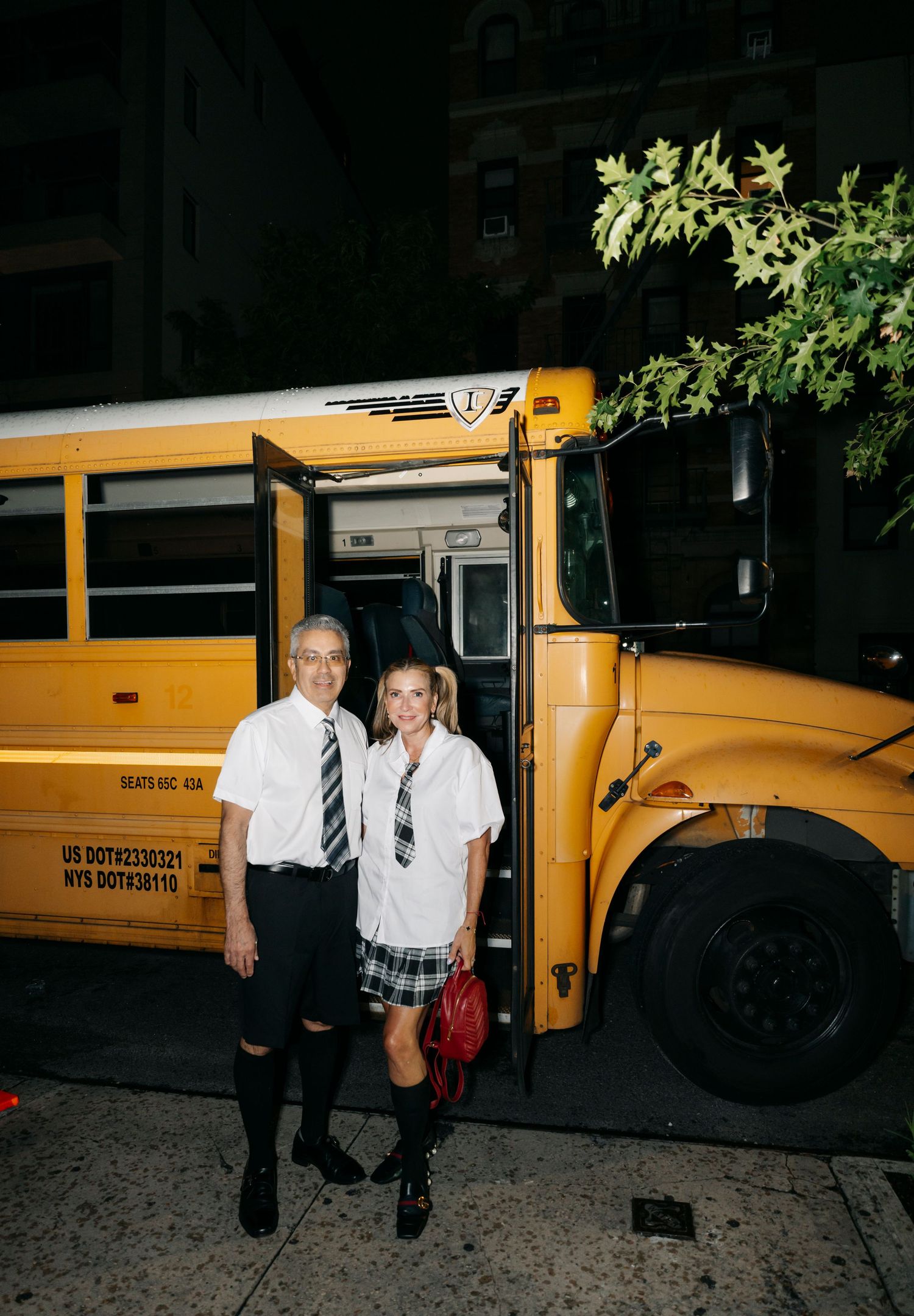 Five consecutive blurry nighttime photos show people stepping out of and walking away from yellow school buses.
