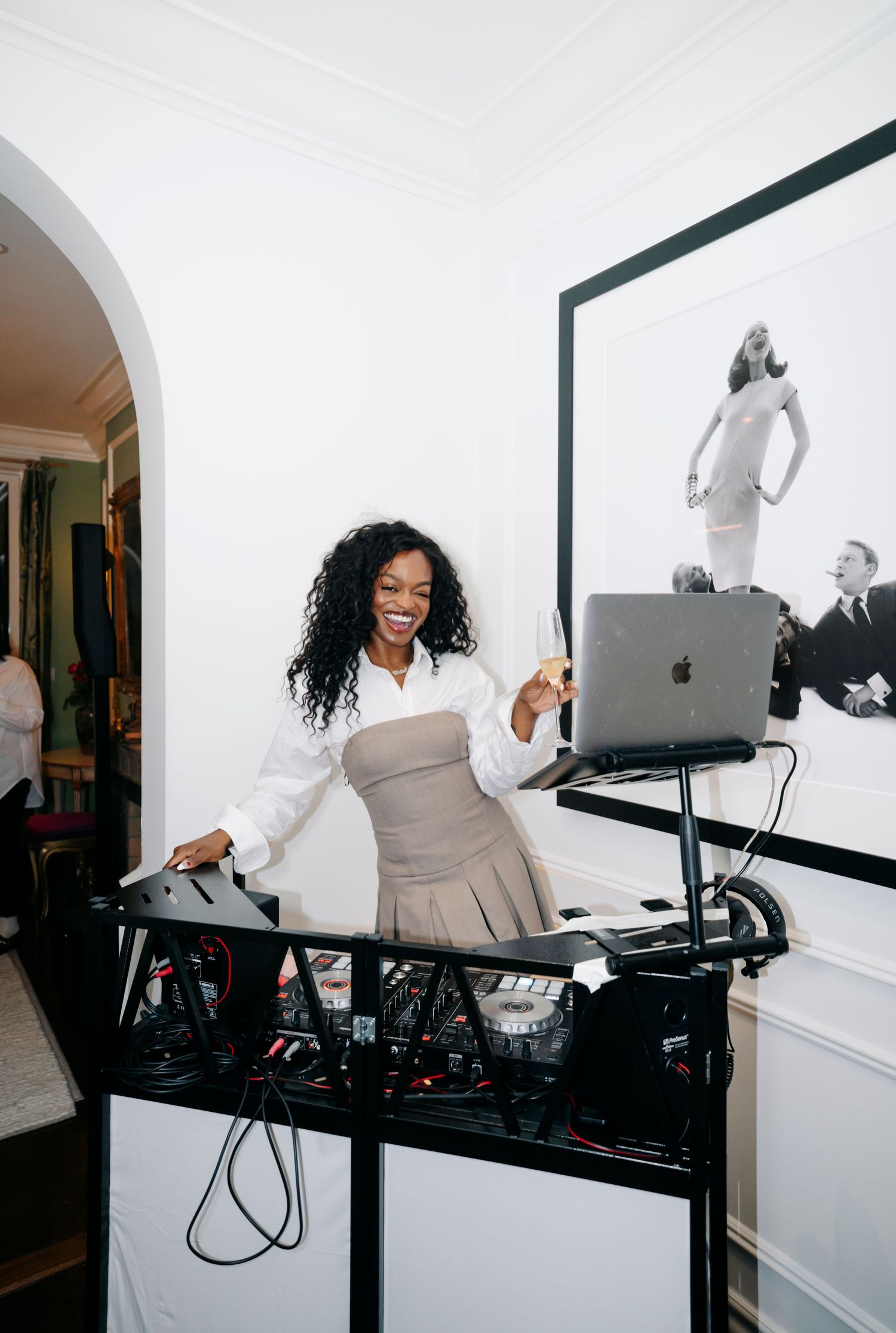 Sequence of photos showing a person in white working at a standing desk against a minimalist white background.