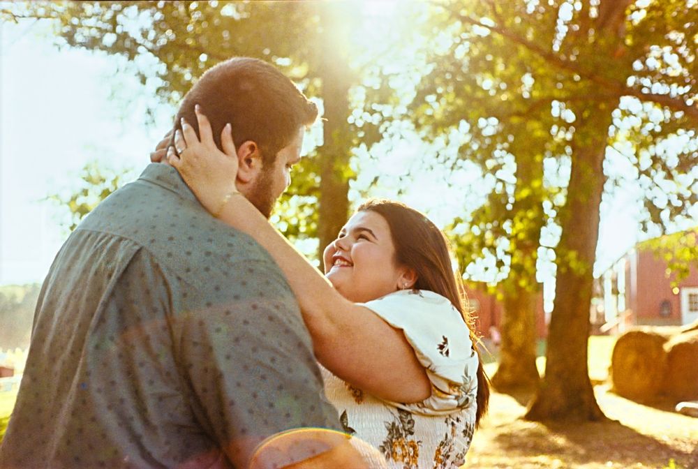 A couple embraces in a romantic outdoor engagement shoot 35mm film Kodak Gold 200 Film.