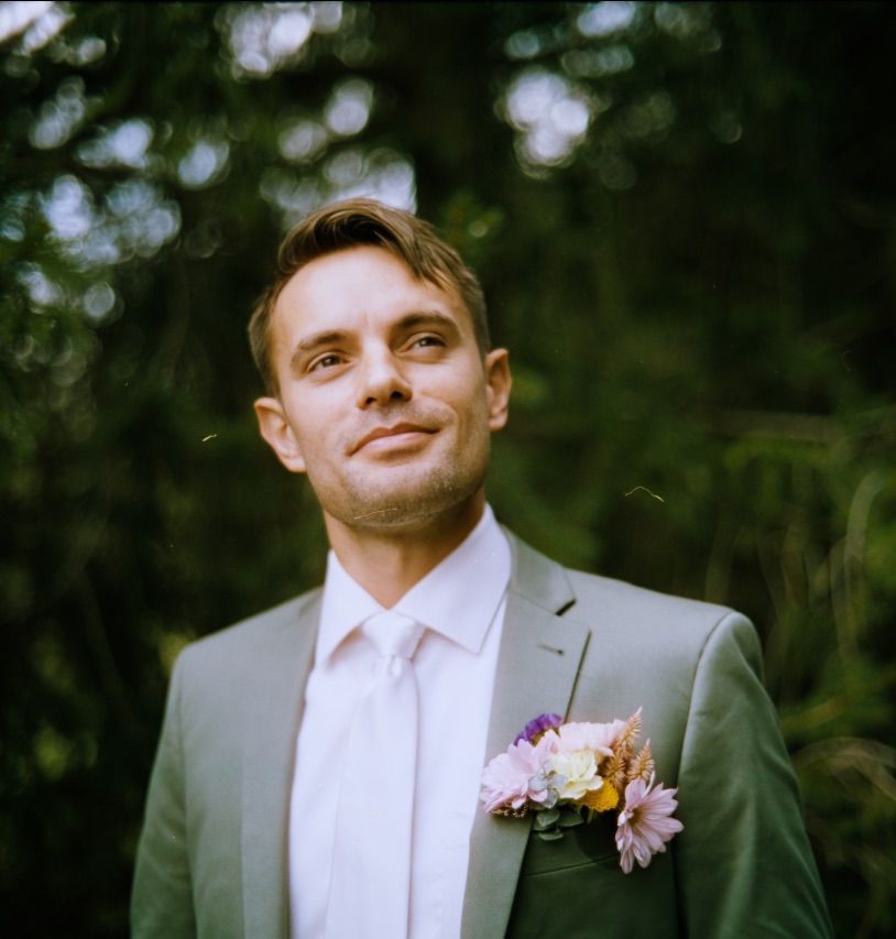 Groom in green suit forest of Pennsylvania vibes on 35mm film.