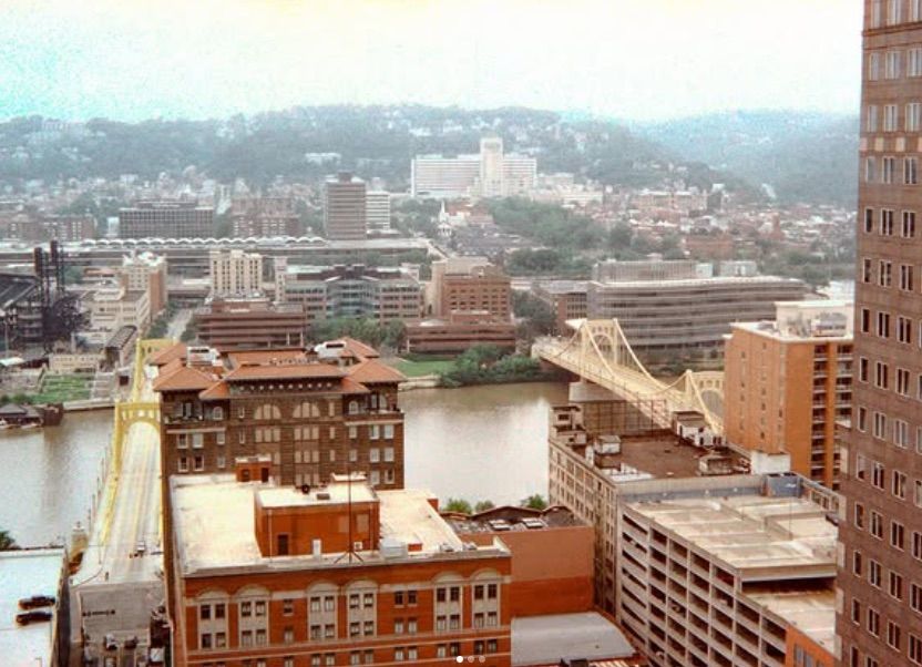 Panoramic cityscape view of downtown buildings and urban architecture against cloudy sky and distant hills. pittsburgh pa cityscape.