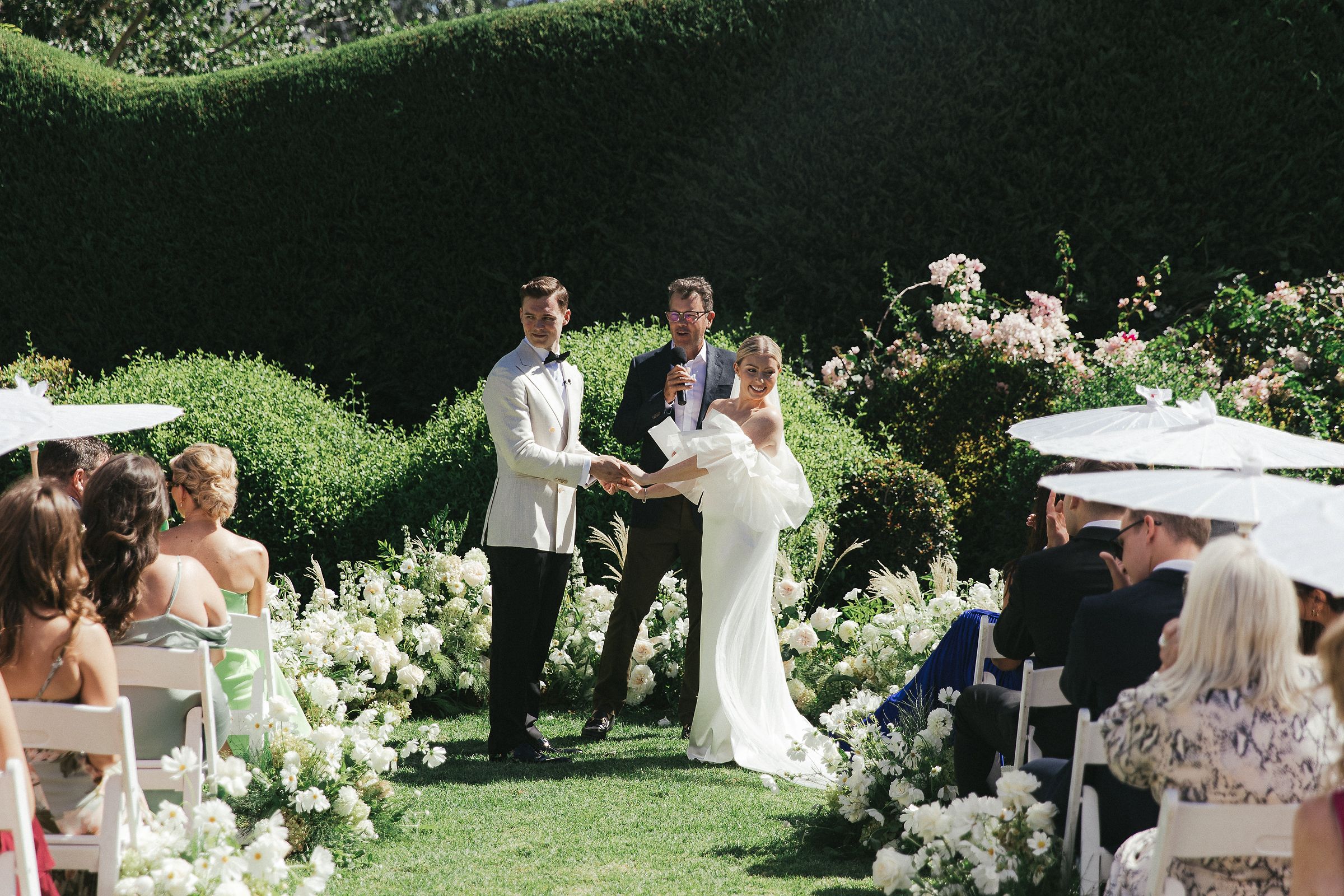 Outdoor ceremony setup at Johannesdal 1207 with white chairs and floral aisle