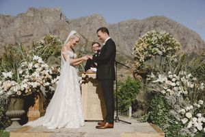 Outdoor ceremony setup at Johannesdal 1207 with white chairs and floral aisle