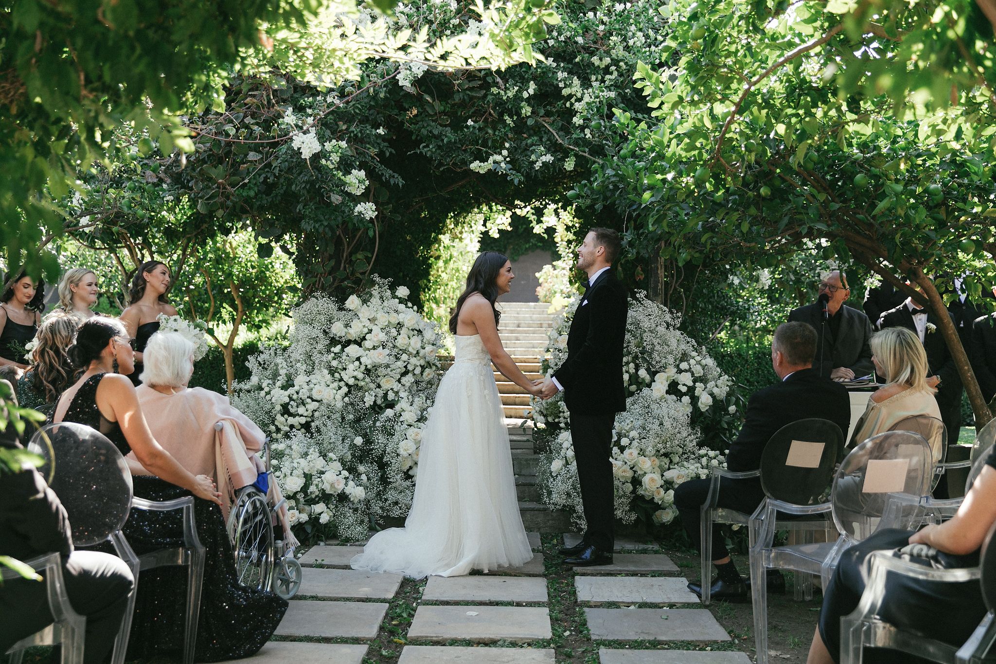 Outdoor ceremony setup at Johannesdal 1207 with ghost chairs and floral aisle
