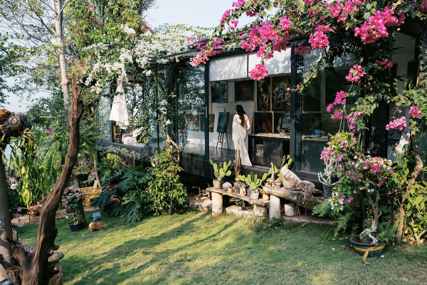 Beautiful garden venue with pink bougainvillea flowers and natural greenery for an outdoor wedding.