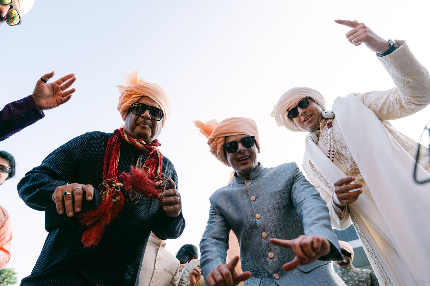 Wedding guests celebrating and dancing outdoors during a festive reception.