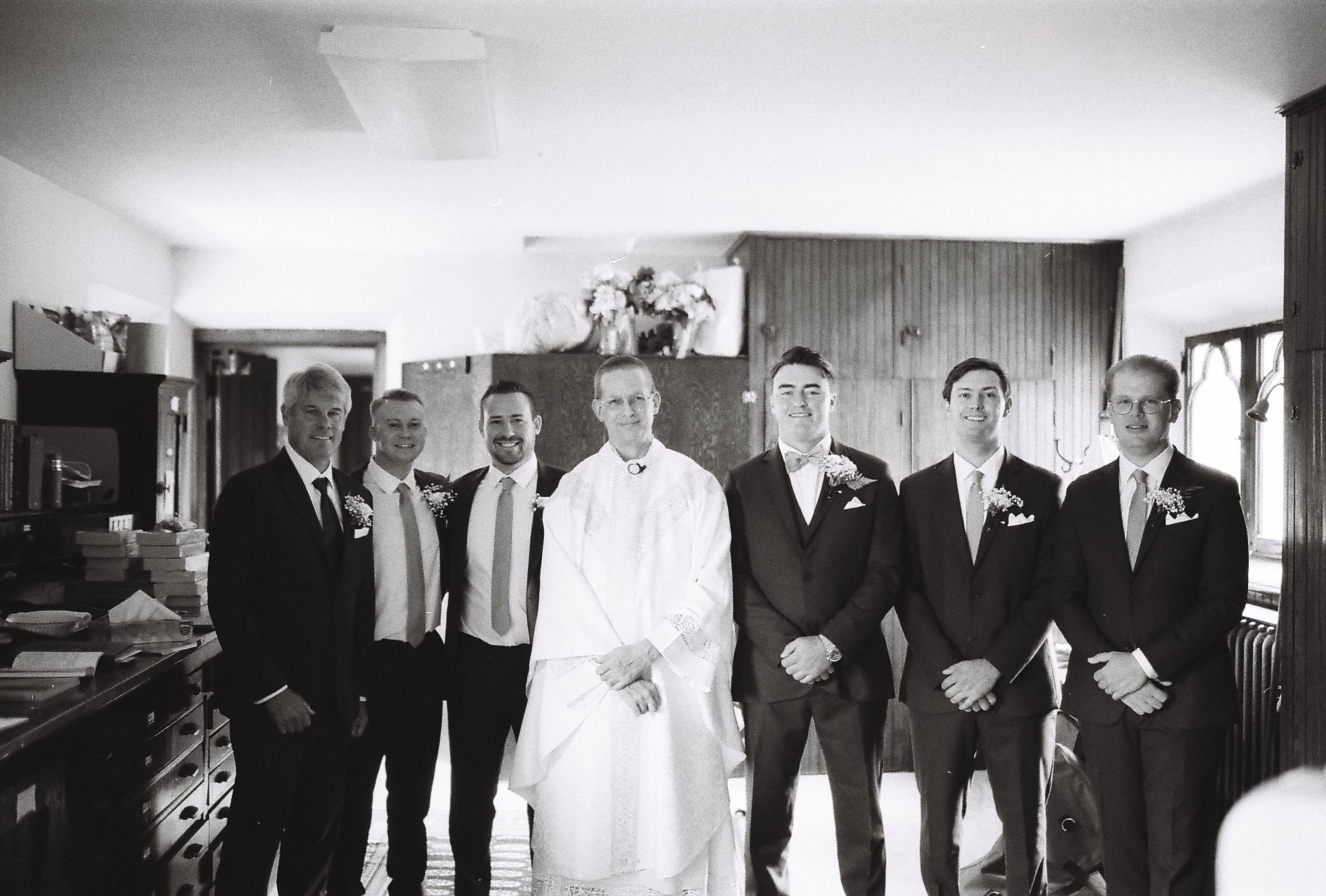 Black and white wedding party group photo showing formal attire and classic composition.
