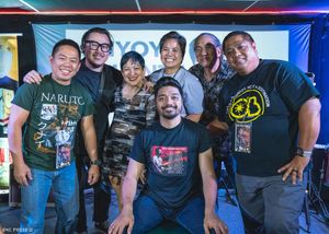 Group photo of Filipino rock band members and supporters smiling after a live concert event at a local venue.