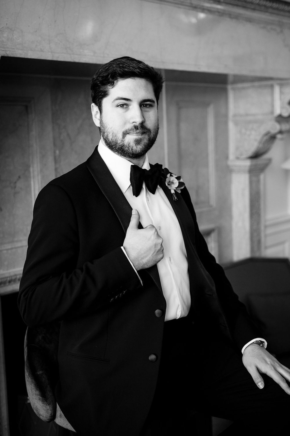 Black and white portraits of a groom in a classic tuxedo and bowtie.