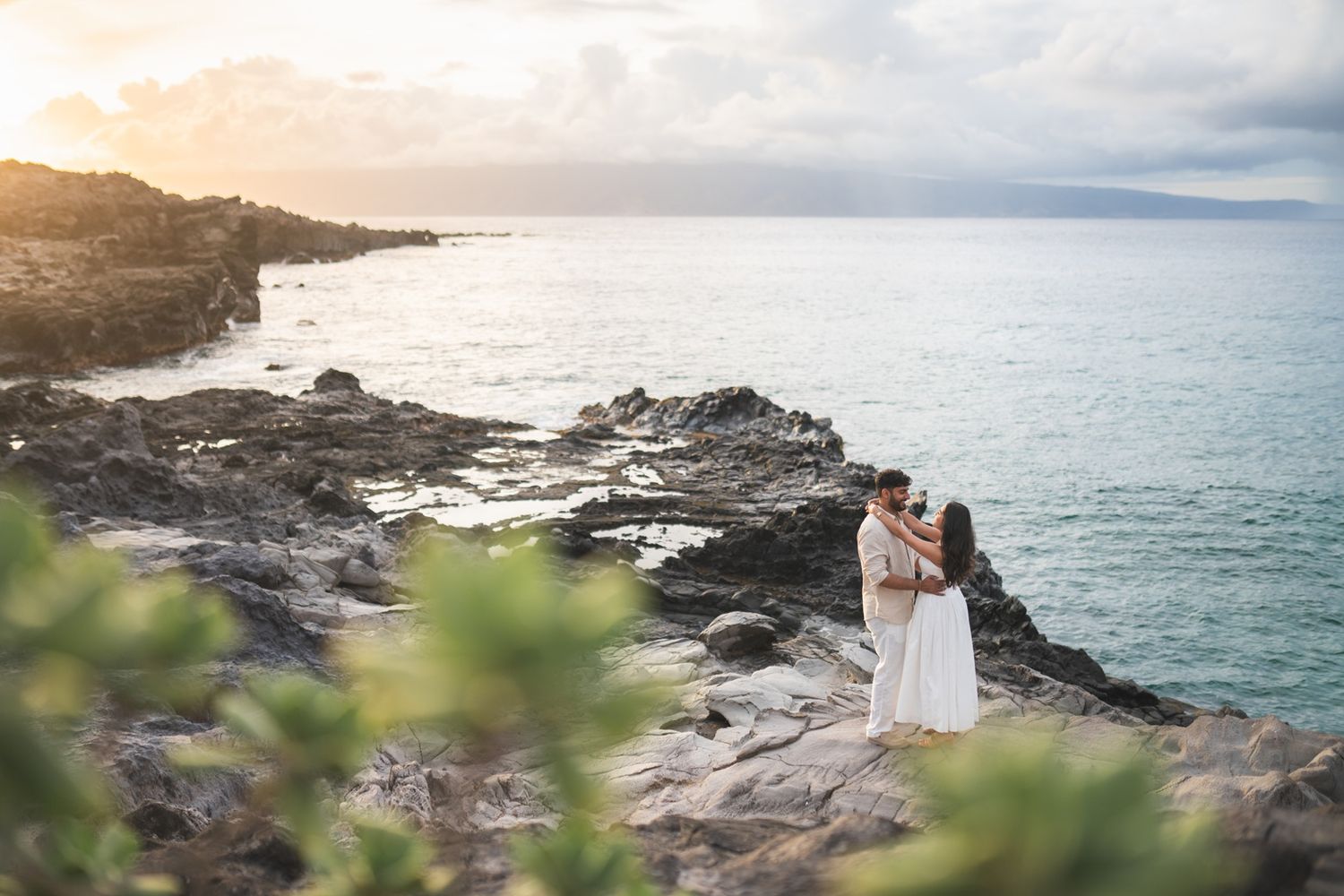 Maui couple proposal engagement photographer photo against beautiful Maui beach cliff sunset by ohwowfotos.