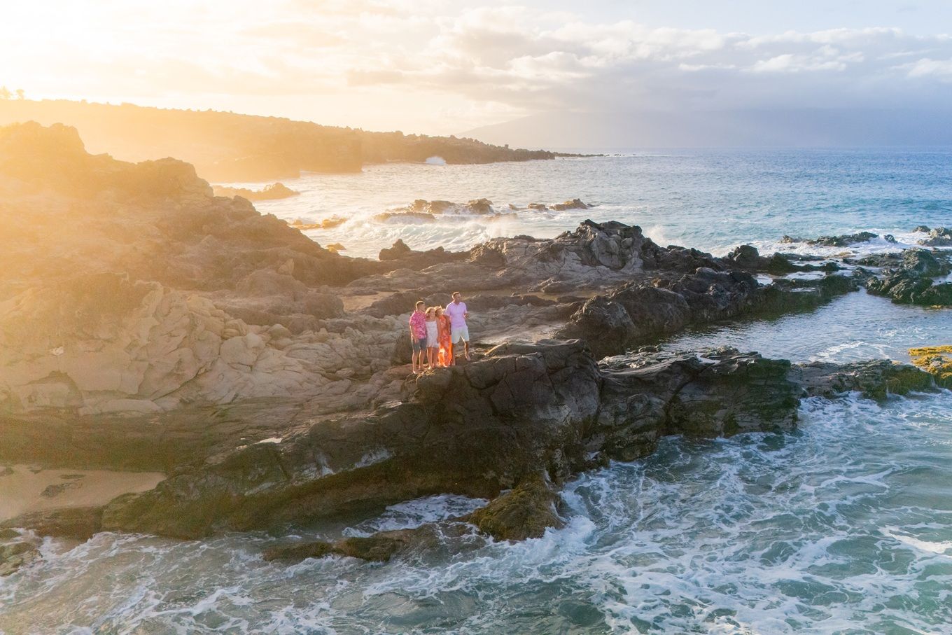 Maui family photographer photo against beautiful Maui beach cliff by ohwowfotos.
